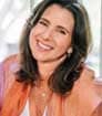 Head shot photo of smiling author Marni Battista with orange blazer