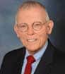 Headshot photo of author NJ in suit and tie