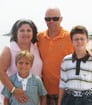 Headshot photo of author SL with wife and two sons